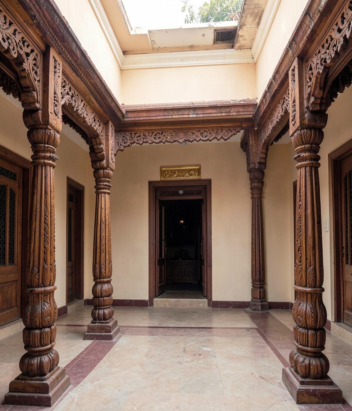 Traditional South Indian courtyard with carved wooden pillars and natural light